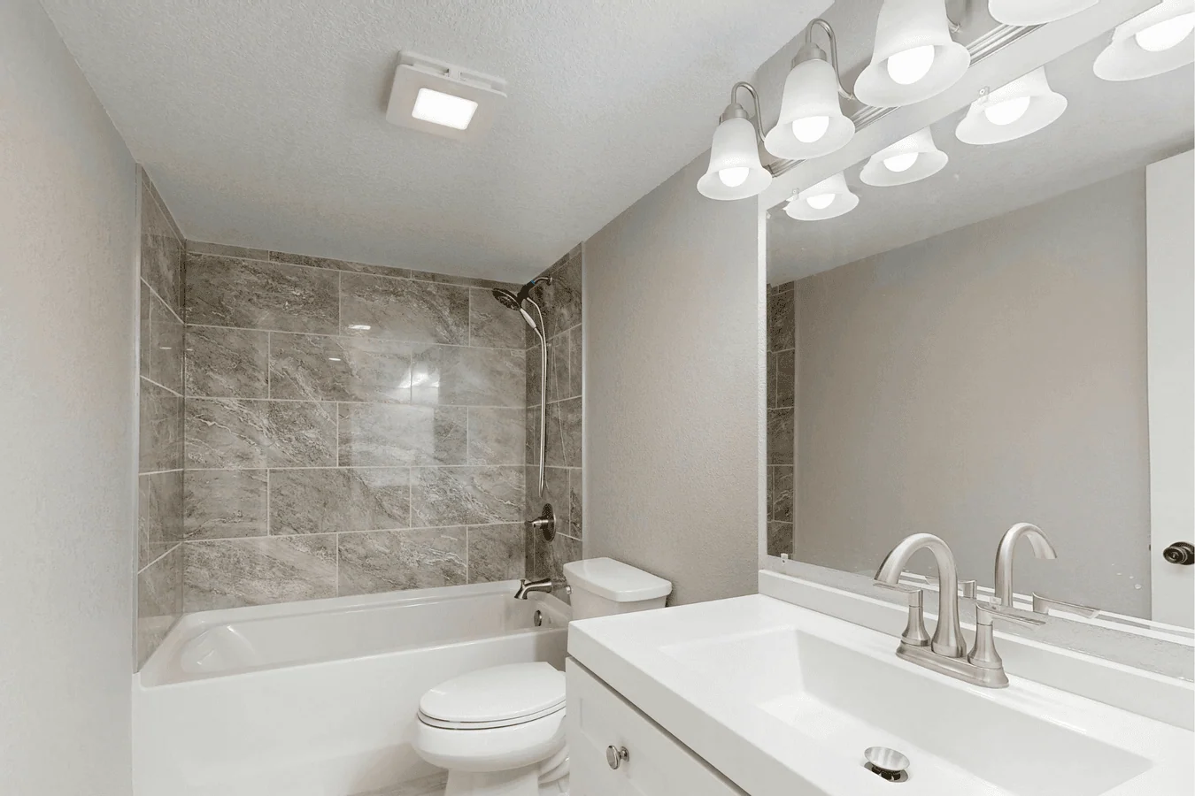 Professionally tiled bathroom with marble-effect wall tiles