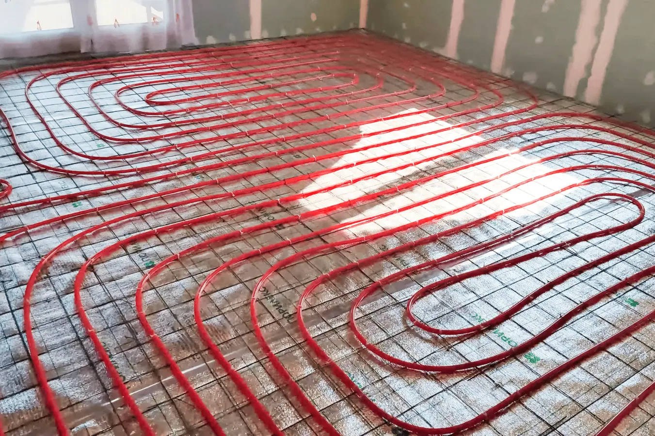 Underfloor heating pipes installation during construction